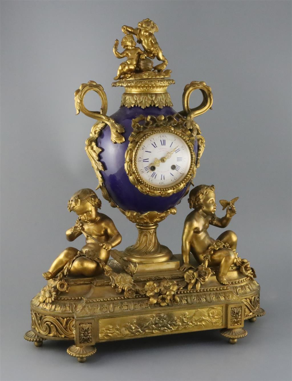 Vernet, Rue du Bac 42. A 19th century French ormolu and bleu du roi porcelain mantel clock, width 19in. depth 7.5in. height 23in.